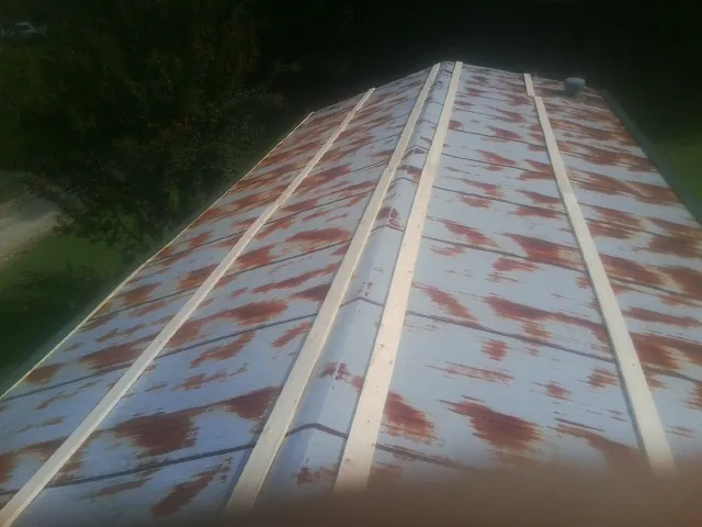 Rusted metal roof panels with new wood purlins before replacement — Storm Damage Roof Repair in Bradfordwoods by Roofing Brothers