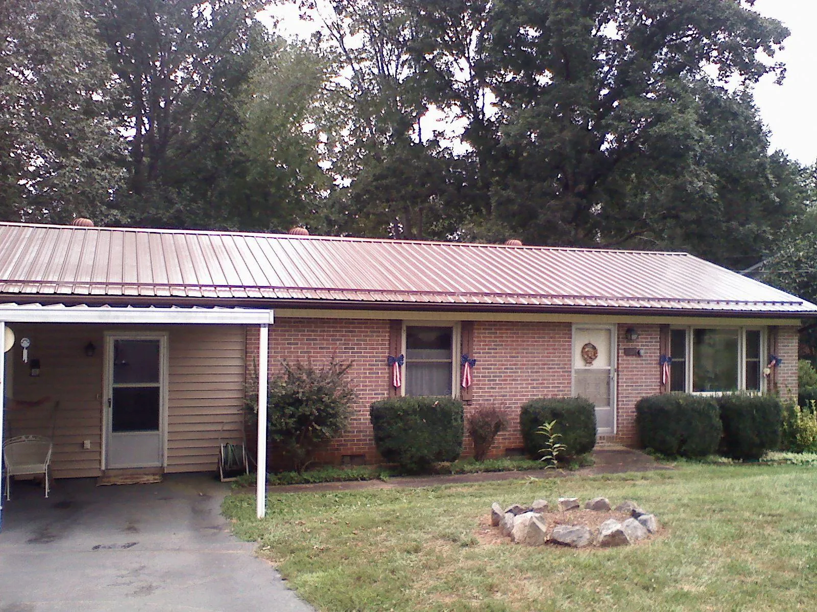 Bronze metal roof and carport on a brick ranch home — Roof Repair work by our crew in Bradfordwoods